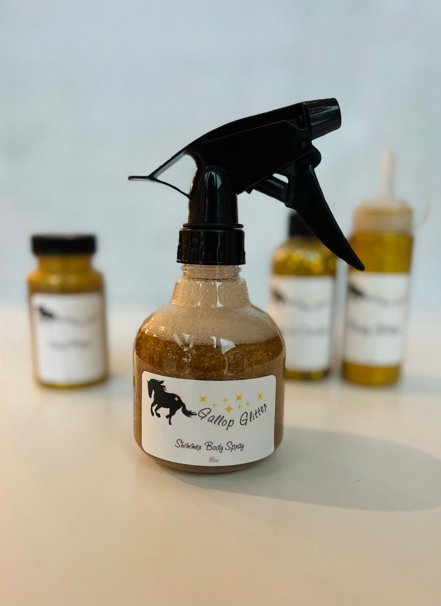 Gallop Glitter Gold set of 4 with shimmer spray in the forefront