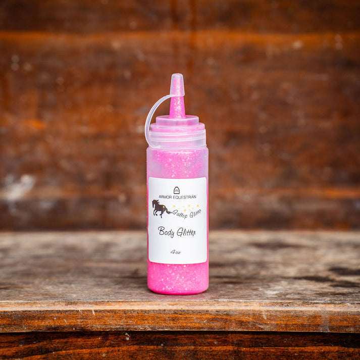 Pink bottle with a white label on a wooden surface