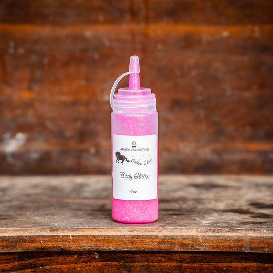 Pink bottle with a white label on a wooden surface