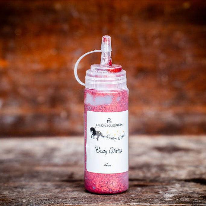 Pink glitter bottle with a label on a wooden surface