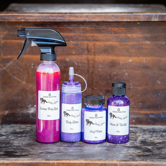 Set of purple and pink bottles with labels on a wooden surface