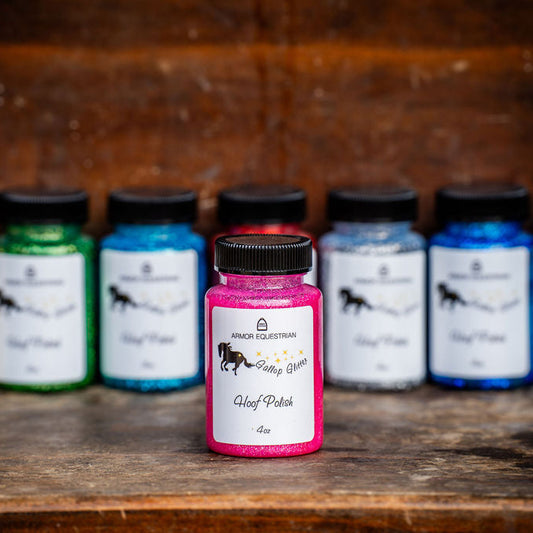 Collection of colorful bottles with labels on a wooden surface