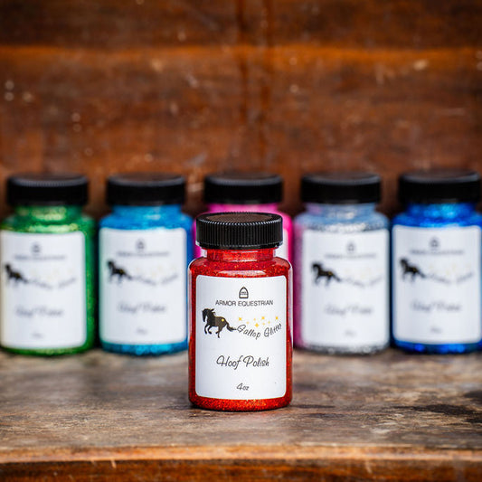 Assorted bottles of hoof polish on a wooden surface with a rustic background