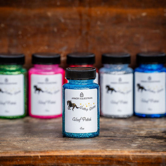 Collection of ink bottles with visible brand logo on a wooden surface