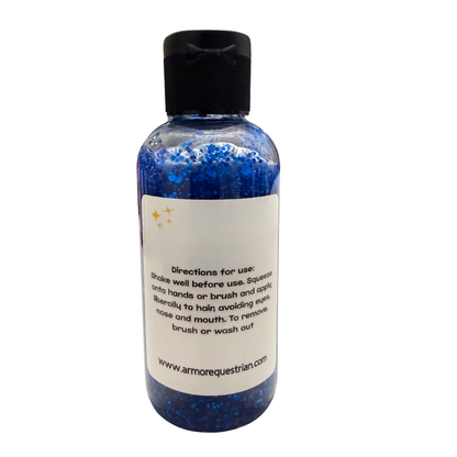 Bottle of blue glittery product with black cap on a white background