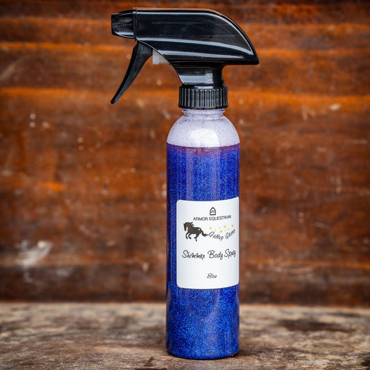 Blue spray bottle with black nozzle on a wooden surface