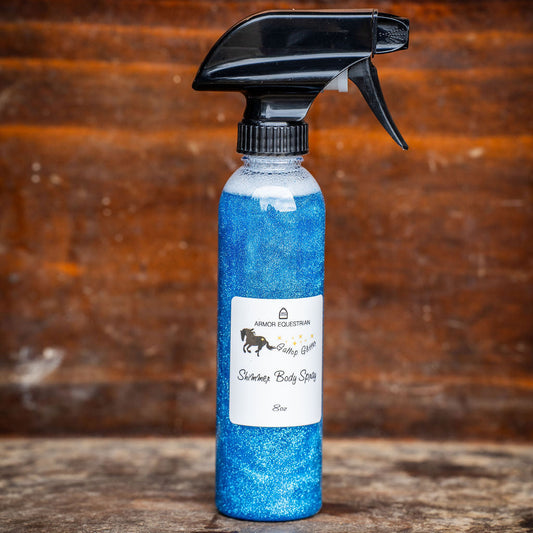Blue spray bottle with black nozzle on a wooden surface