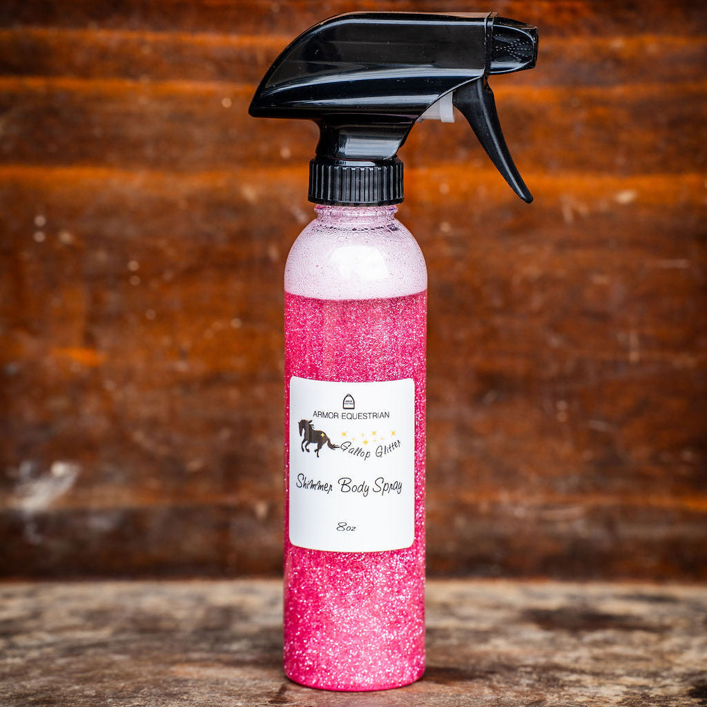 Pink spray bottle with black nozzle on a wooden surface