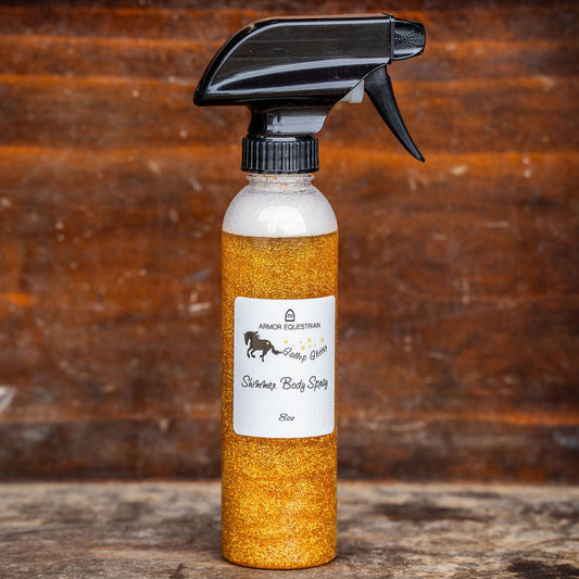 Spray bottle with orange liquid on a wooden surface