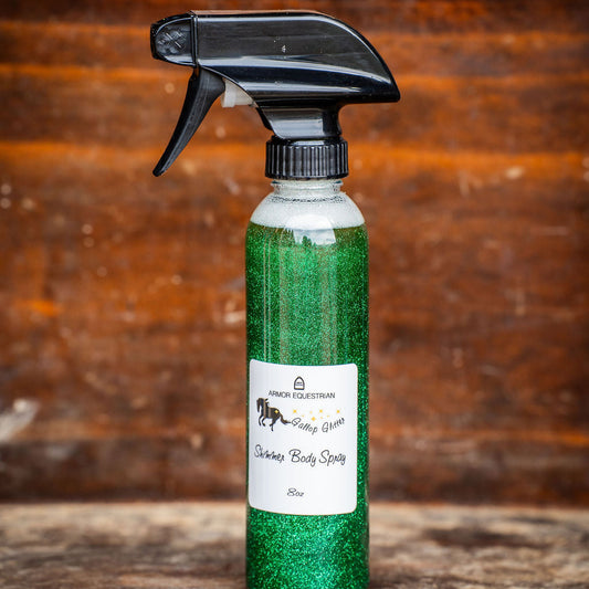 Green spray bottle with black nozzle on a wooden surface
