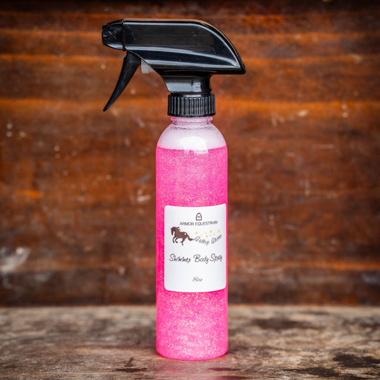 Pink spray bottle with black nozzle on a wooden surface