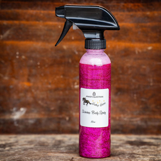 Pink spray bottle with black nozzle on a wooden surface