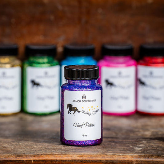 Bottle of hoof polish with a row of colorful bottles in the background on a wooden surface.
