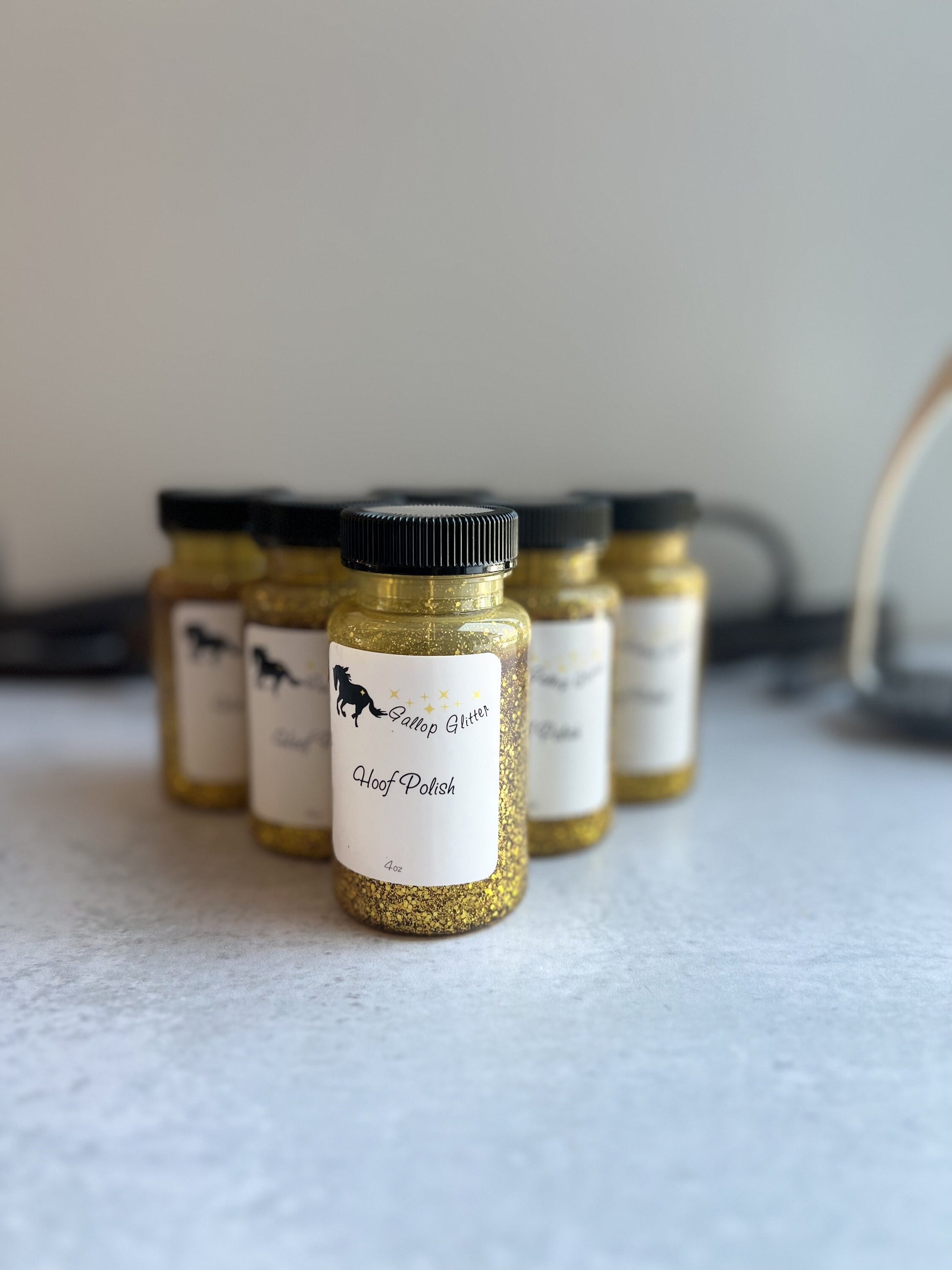 Gallop Glitter Gold Hoof Polish arranged in a pyramid