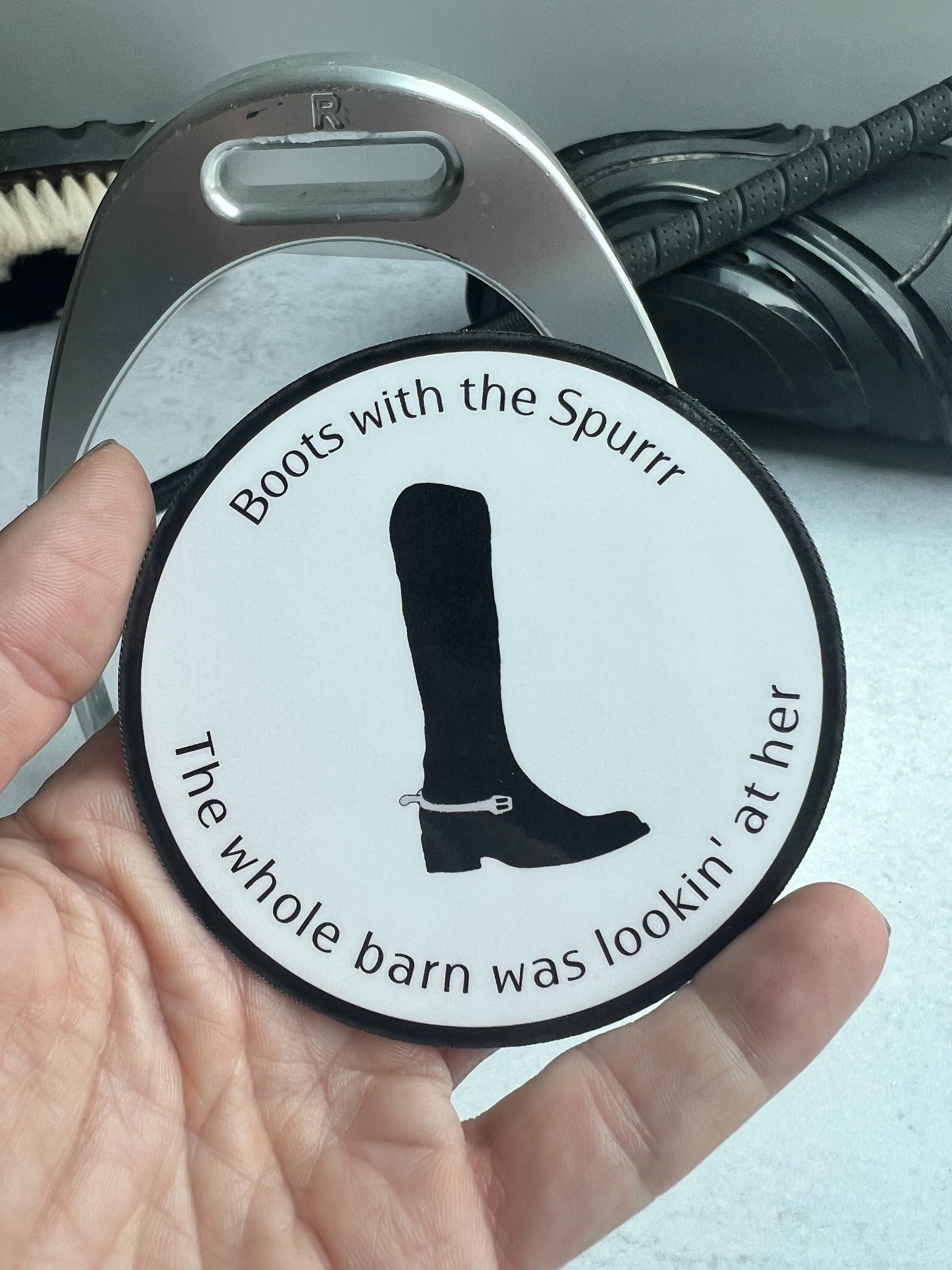 Boots with the spur sticker in hand for scale