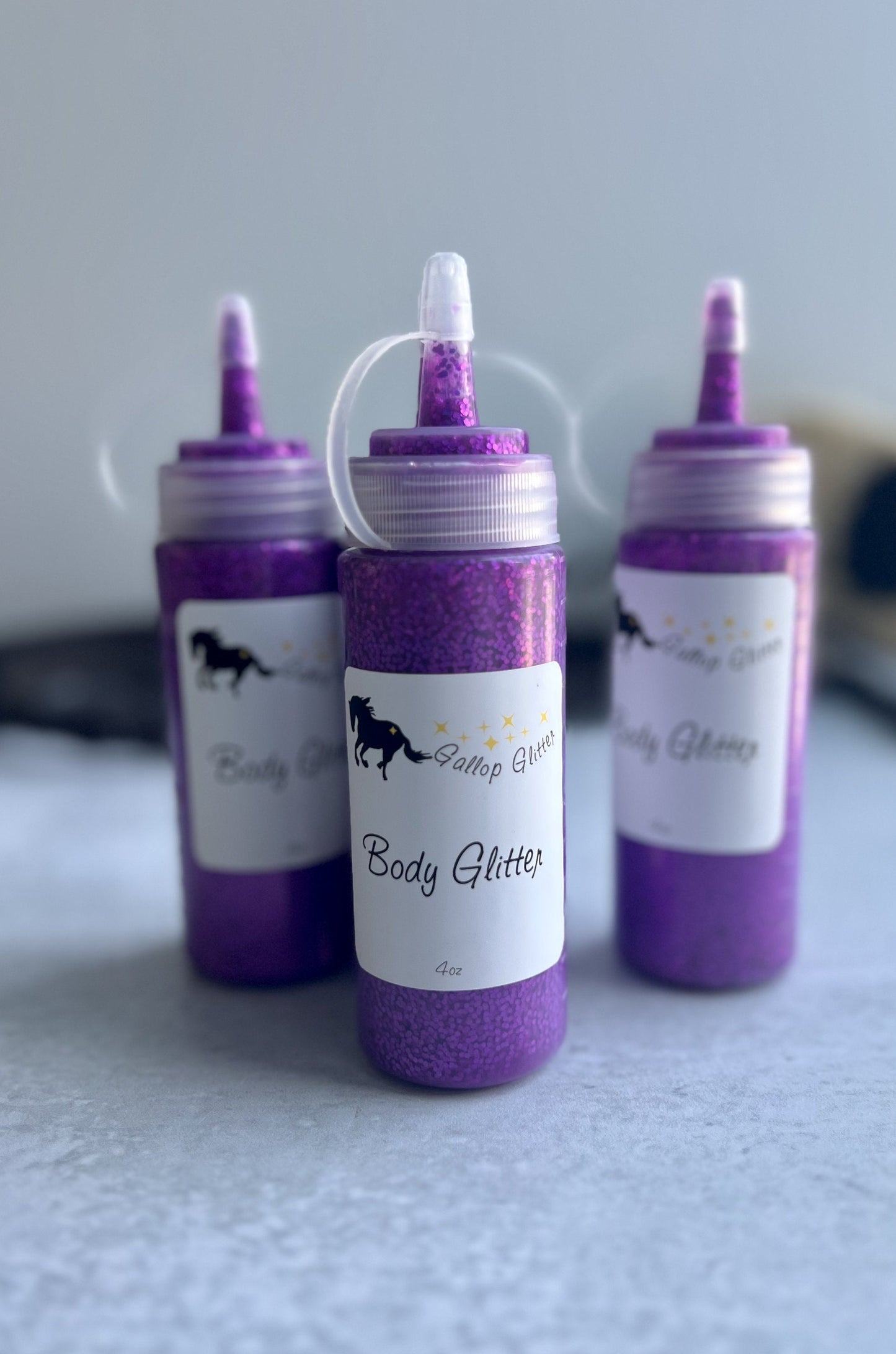 bottles of Gallop Glitter purple body glitter